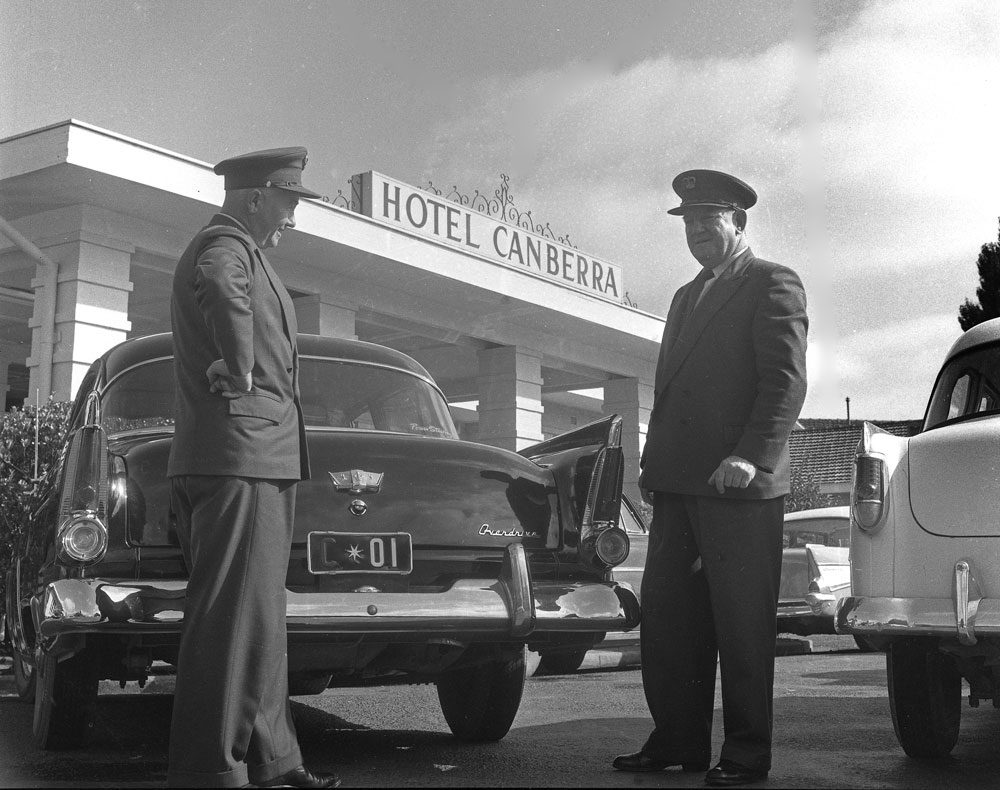 Prime Ministerial car outside the Hotel Canberra, c.1958 Commonwealth car drivers stand beside the Prime Ministerial car outside the Hotel Canberra in Commonwealth Avenue, Canberra, c. 1958